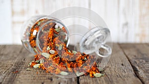 The use of flowers Chernobrovtsy or Mary is Gold in folk alternative medicine. Dried marigold flowers in a glass jar for storage