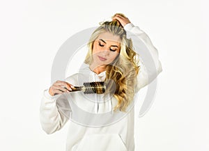 Use with hairdryer to create styling. Hot curling brush. Pretty woman brushing hair isolated on white. Long hair. Hair