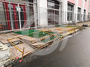 Use other footpath traffic warning sign barrier applying on busy street downtown on pedestrian footpath, road under construction