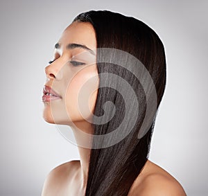 Use products that are specially formulated for your hair type. Studio shot of an attractive young woman posing against a