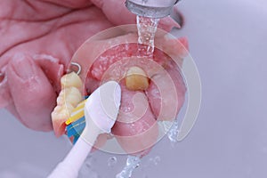 Use a toothbrush to clean teeth partial denture