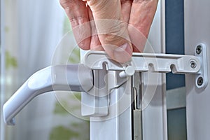 Use of window limiter for ventilation of premises, close-up.