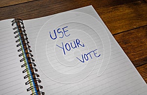 Use your vote, handwriting  text on paper, political message. Political text on office agenda. Concept of democracy, voting,