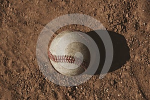 Used baseball on field dirt with copy space