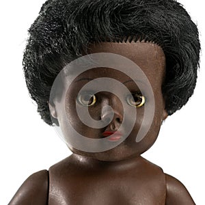 Used black doll in front of a white background