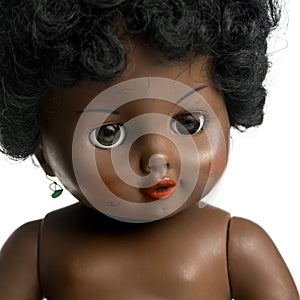 Used black doll in front of a white background