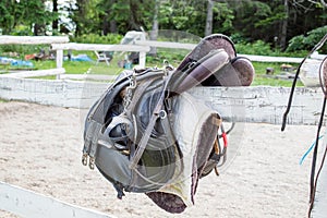 Used black dressage horse riding saddle with girth, stirrup and riding gloves