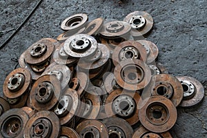 Used brake rotor and car part at junkyard or scrapyard for recycling