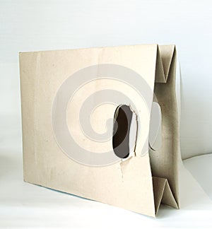 A used brown paper bag on a white background.