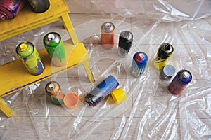 Used cans of spray paints indoors, above view. Graffiti supplies