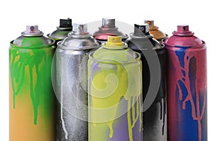 Used cans of spray paints on white background. Graffiti supplies