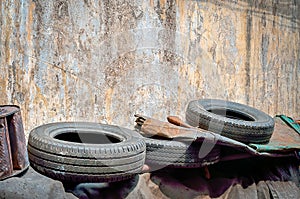 Used car tires with old cracked paint wall