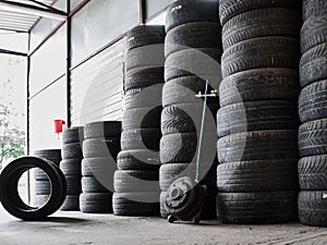 Used car tires stacked in piles at tire fitting service. Wheels for repair shop. Car service concepr