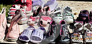 Used child and baby shoes for reusing at flea market photo