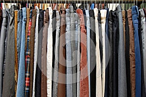Used clothing on thrift store rack photo