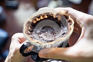 Used coffee ground left in a coffee dripper. Coffee grounds can be used as a fertilizer.