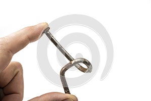 Used crooked rusty nailes on a white. Perseverance and strength