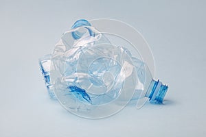 Used crushed pet plastic bottles on blue