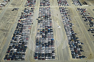 Used damaged cars on auction reseller company big parking lot ready for resale services. Sales of secondhand vehicles