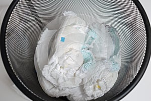 Used diapers in bin, top view.