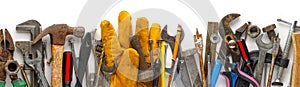 Used and dirty work tools for home improvement or diy repair projects. Includes wrench, work gloves, hammer, measuring tape,