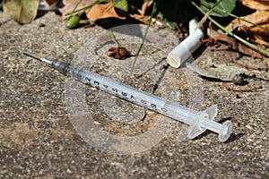 Used and discarded syringe on the street