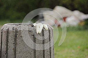 Used disposable glove on a garbage container close up. Disposal of personal protective equipment concept. selective focus