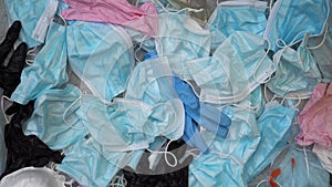 Used disposable personal protective equipment against the coronavirus pandemic. Plastic face masks, gloves, sanitizers