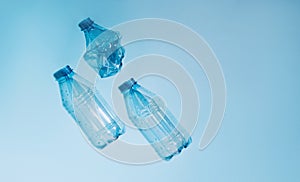 Used empty crumpled plastic bottles on blue background. Recycling recycled plastic. Pollution, environmental protection.