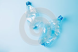 Used empty crumpled plastic bottles on blue background. Recycling recycled plastic. Pollution, environmental protection.