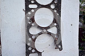 Used engine gasket on the wall background