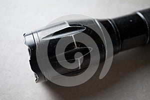 Used flashlight shocker on a light background close-up, the concept of protection and security photo