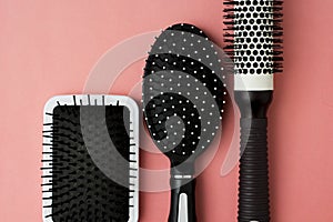 Used Hair brush tools on pink or coral background with copy space. Beauty fashion, hair care background