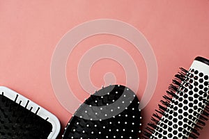 Used Hair brush tools on pink or coral background with copy space. Beauty fashion, hair care background