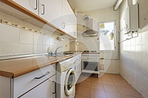 Used kitchen from a cheap apartment with natural gas boiler and gas cooker