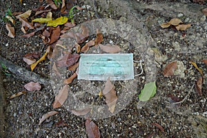 Used medical face mask on the ground. Environmental pollution concept and discarded mask concept corona virus,covid-19.