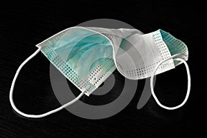 A used medical face mask protecting against respiratory diseases transmitted by airborne droplets such as coronavirus