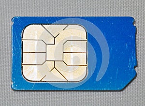 Used mobile phone sim card macro on white