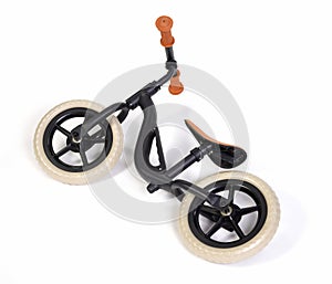 Used modern black balace bike for a small child, isolated
