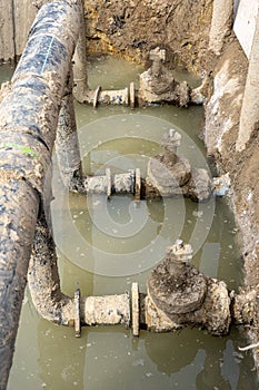 Used muddy water pipe valve in a trench