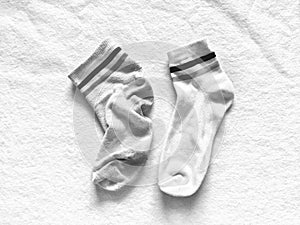 Used and new socks isolated on softness white cotton background