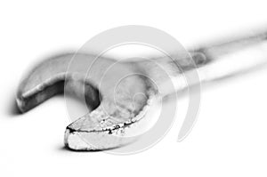 Used old wrench closeup isolated white background