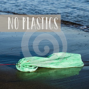 Used plastic bag in the sea and text no plastics