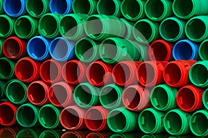 Used plastic barrels. Blue, green, and red plastic drum. Stacked of empty tank in food factory waiting for recycle and reuse.