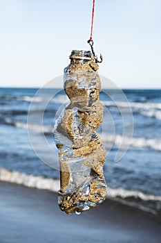 Used plastic bottle in a fish hook