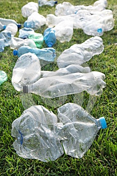 Used plastic bottles abandoned in a meadow