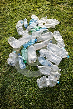 Used plastic bottles abandoned in a meadow