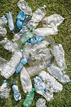 Used plastic bottles abandoned in a meadow