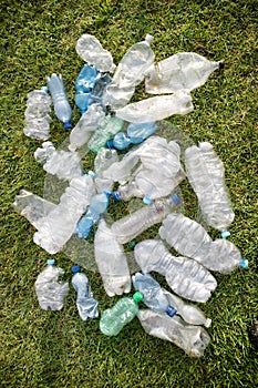 Used plastic bottles abandoned in a meadow