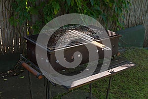 Used rectangular charcoal grill and grill grates outdoor
